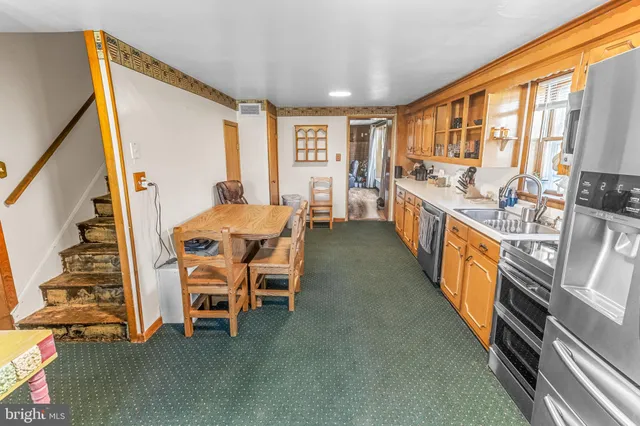 a large kitchen with a table and chairs