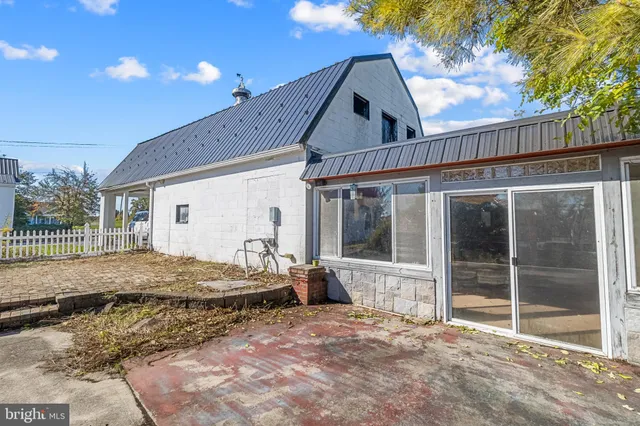 a backyard of a house with barbeque oven