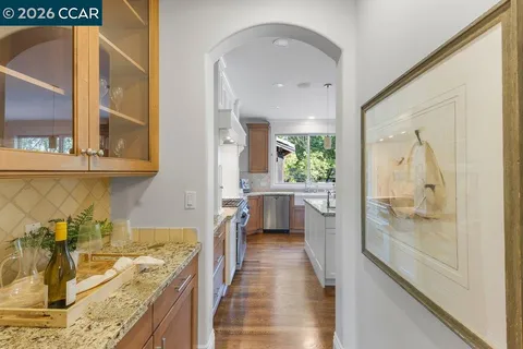 a bathroom with a granite countertop sink mirror and a shower