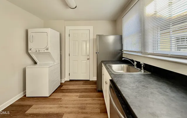 a kitchen with a sink and a stove top oven