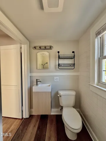 a white toilet sitting next to a bathroom sink
