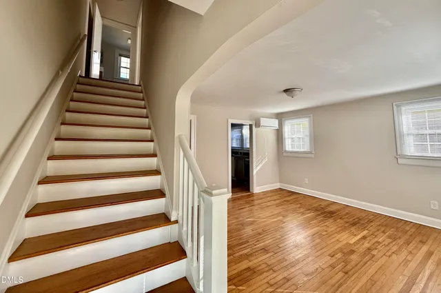 a view of entryway with wooden floor and stairs