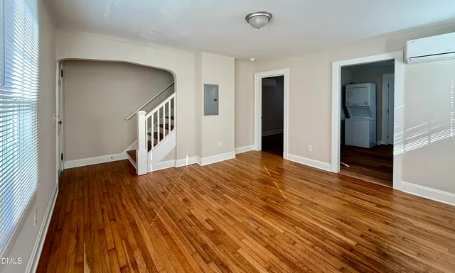 a view of a room with wooden floor and stairs