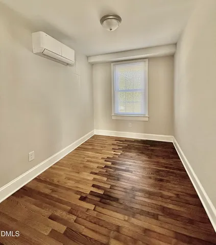 a view of room with window and wooden floor