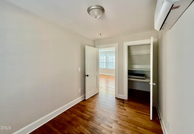 a view of a room with wooden floor