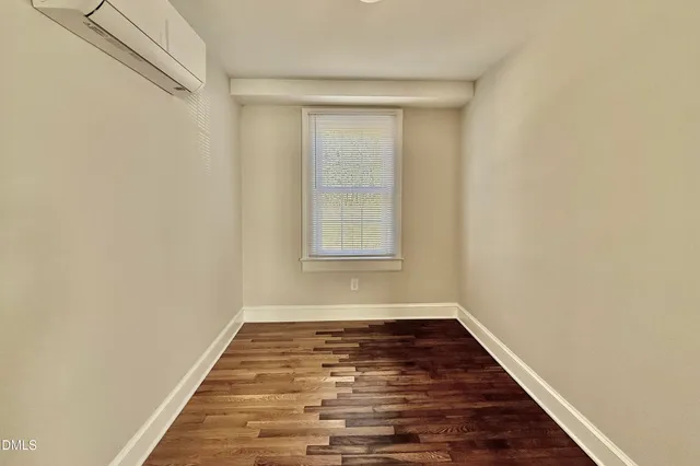 a view of a room with wooden floor and window