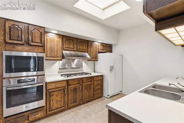 a kitchen with stainless steel appliances a stove and a refrigerator