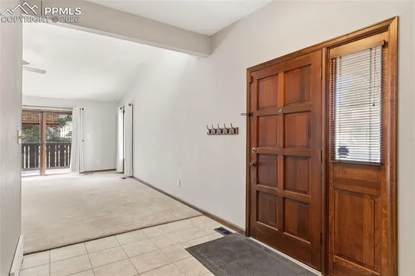 a view of an empty room with a fireplace and a window