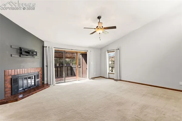 a view of a room with a chandelier and wooden floor