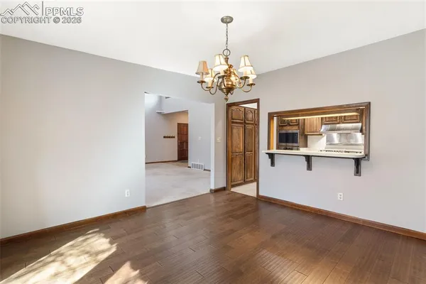 a white stove top oven sitting inside of a kitchen