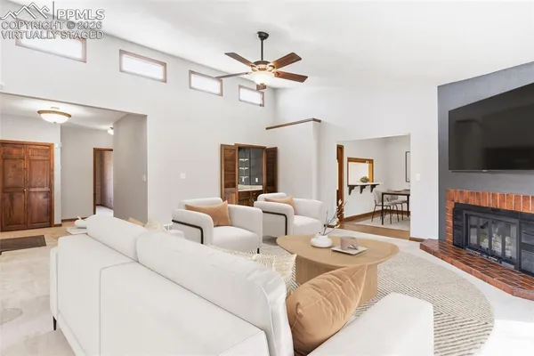 a living room with furniture a flat screen tv and a fireplace