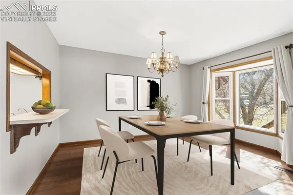 a view of a dining room with furniture window and wooden floor