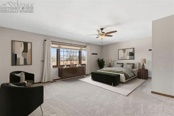 a spacious bedroom with a bed and a couch