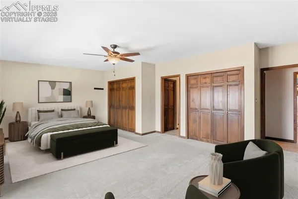 a spacious bedroom with a bed and a chandelier
