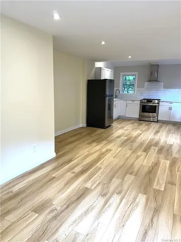 a view of kitchen with microwave and furniture