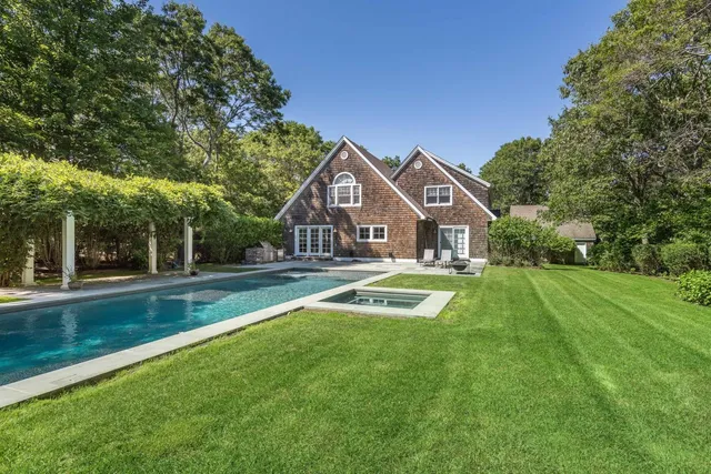 a front view of house with yard and green space