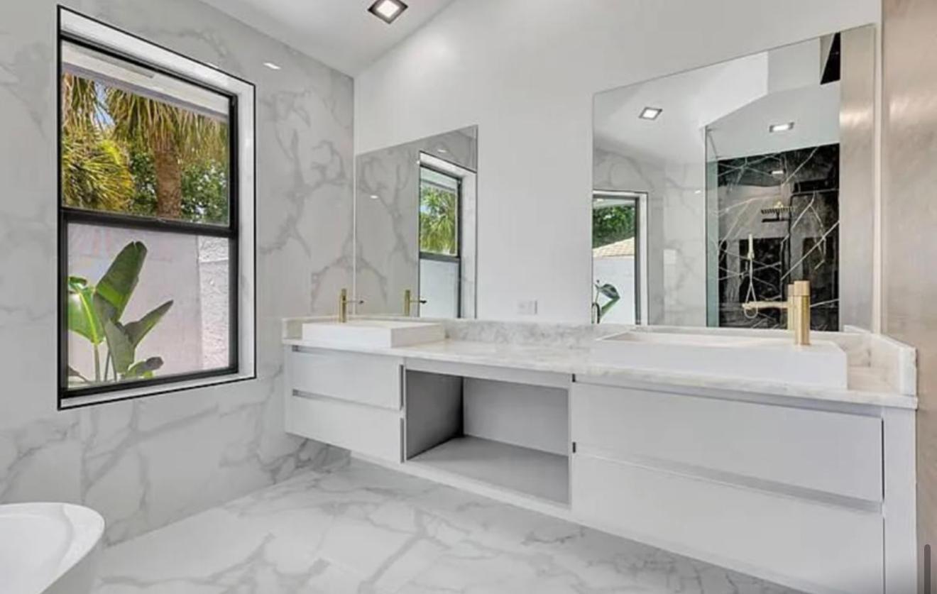 2299 Northwest 55th Street Boca Raton, FL 33496 - Photo 19 of 47 a bathroom with a sink and a large mirror