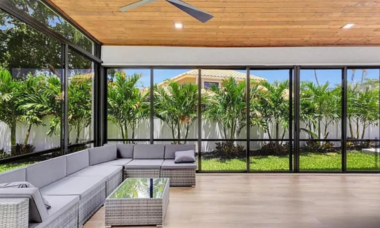 2299 Northwest 55th Street Boca Raton, FL 33496 - Photo 31 of 47 a view of a patio with couches and a table and chairs
