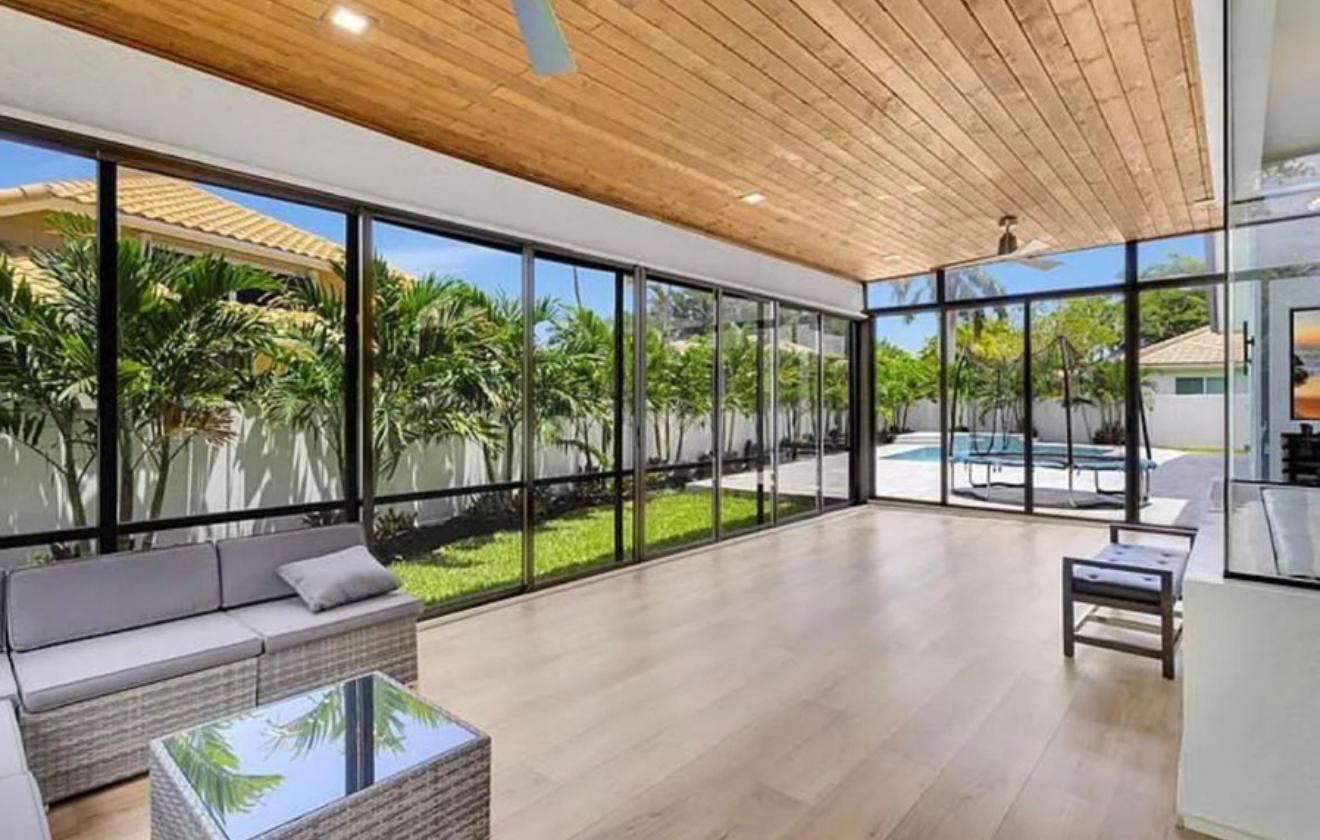 2299 Northwest 55th Street Boca Raton, FL 33496 - Photo 32 of 47 a view of an empty room with wooden floor and windows