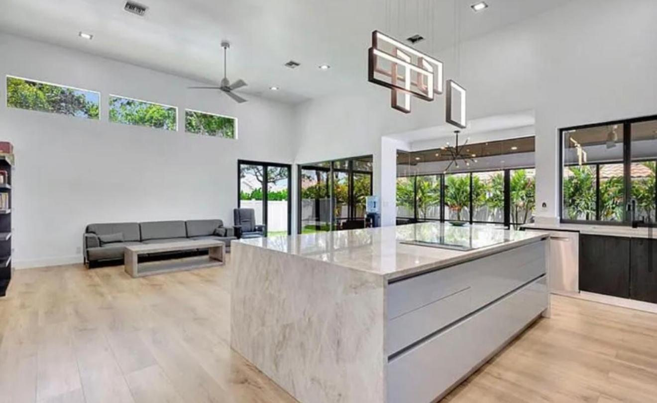 2299 Northwest 55th Street Boca Raton, FL 33496 - Photo 10 of 47 a living room with furniture and a large window