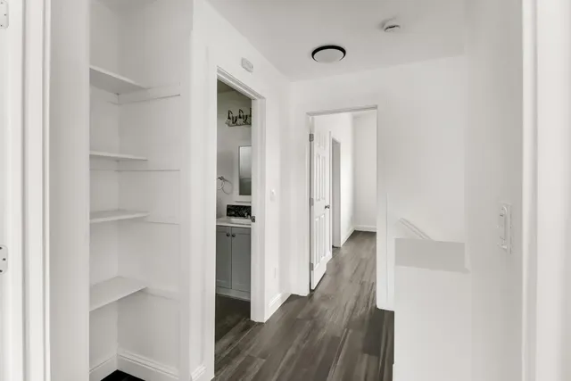 a view of a hallway with wooden floor
