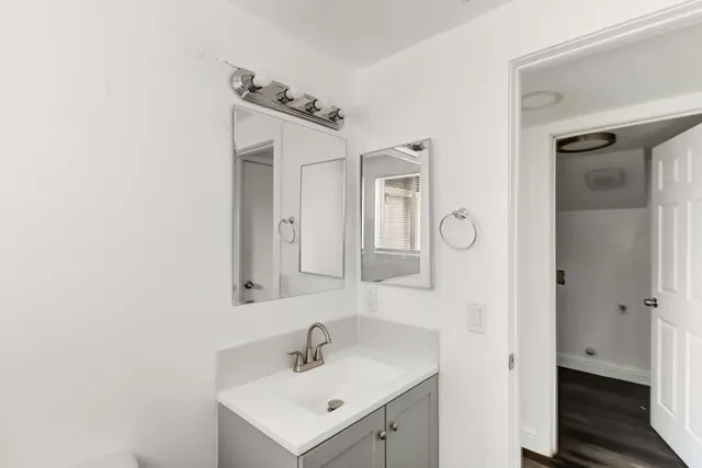 a bathroom with a sink a mirror and a shower