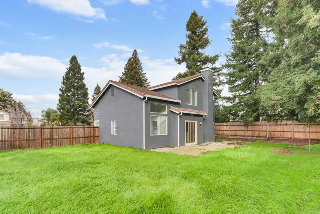 a view of a house with yard and a garden