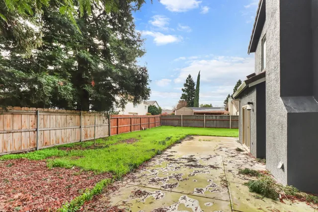 a view of a backyard of the house