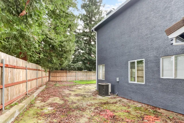 a front view of a house with a garden and yard