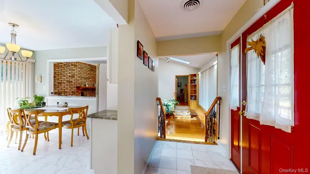 a living room with furniture a window and a flat screen tv