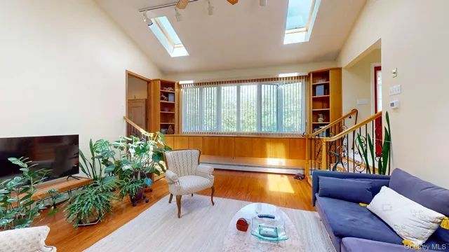a living room with furniture and a potted plant