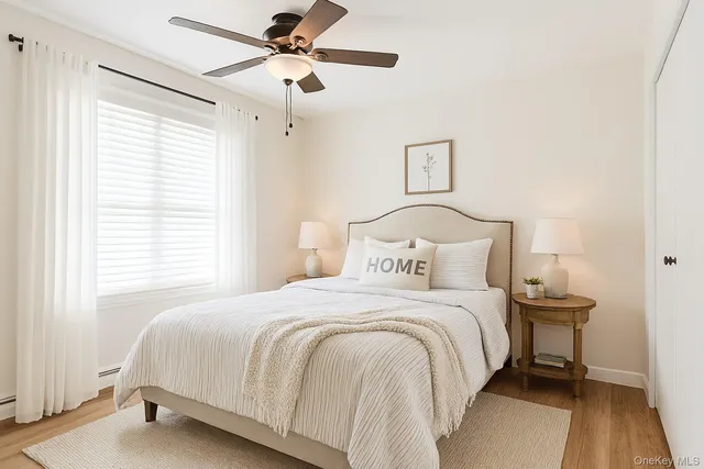a bedroom with a bed and a ceiling fan