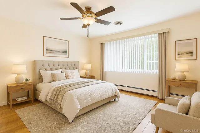 a bedroom with a bed couches and window