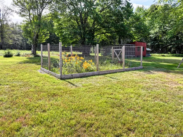 a view of a backyard with wooden fence