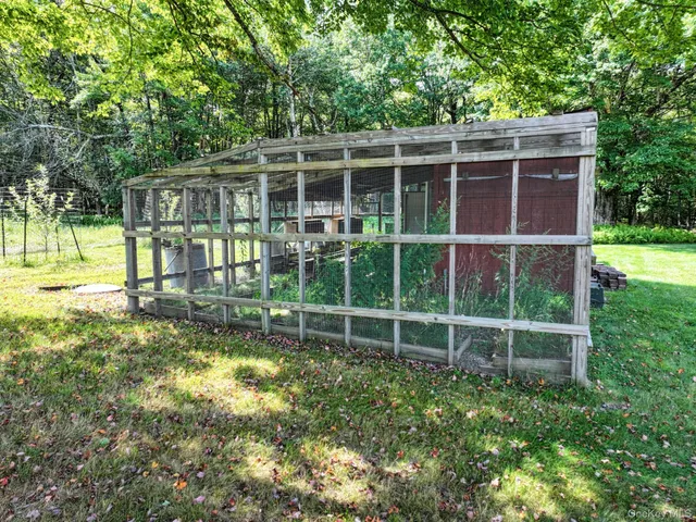 a view of an house with backyard space and balcony