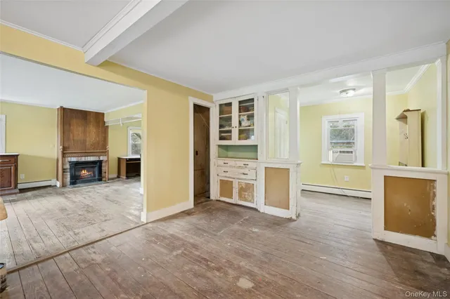 an empty room with kitchen and windows