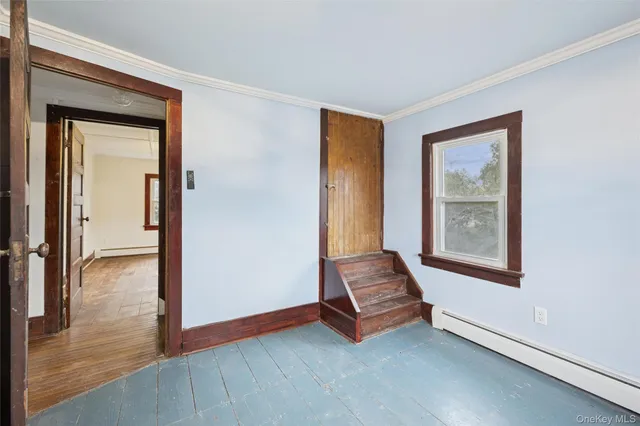 an empty room with windows and closet