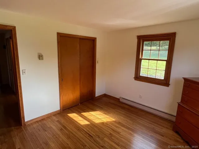 a bathroom with a granite countertop toilet sink and mirror