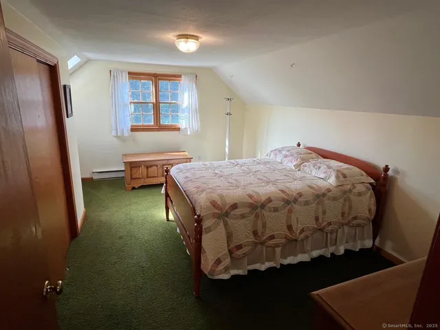 a bedroom with a bed and closet with window