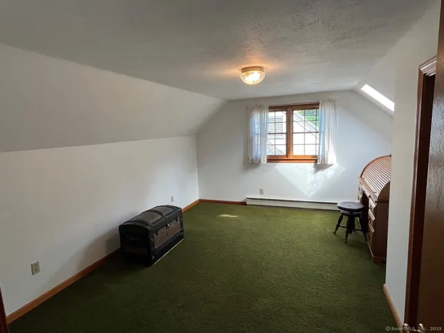 a room with pool table and a window