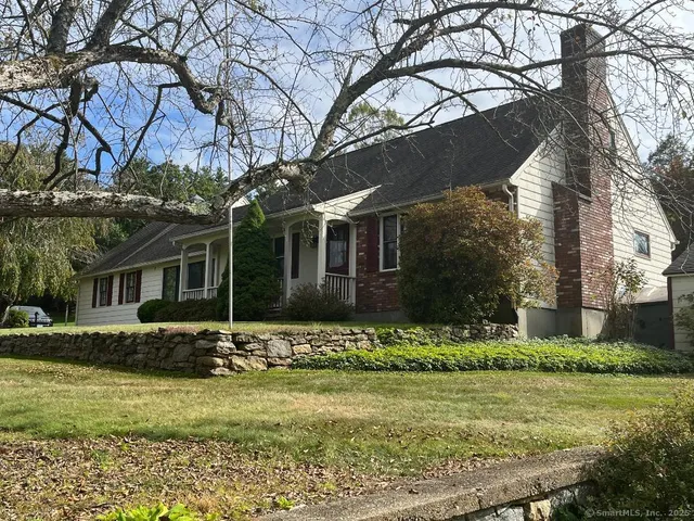 a front view of house with yard and green space