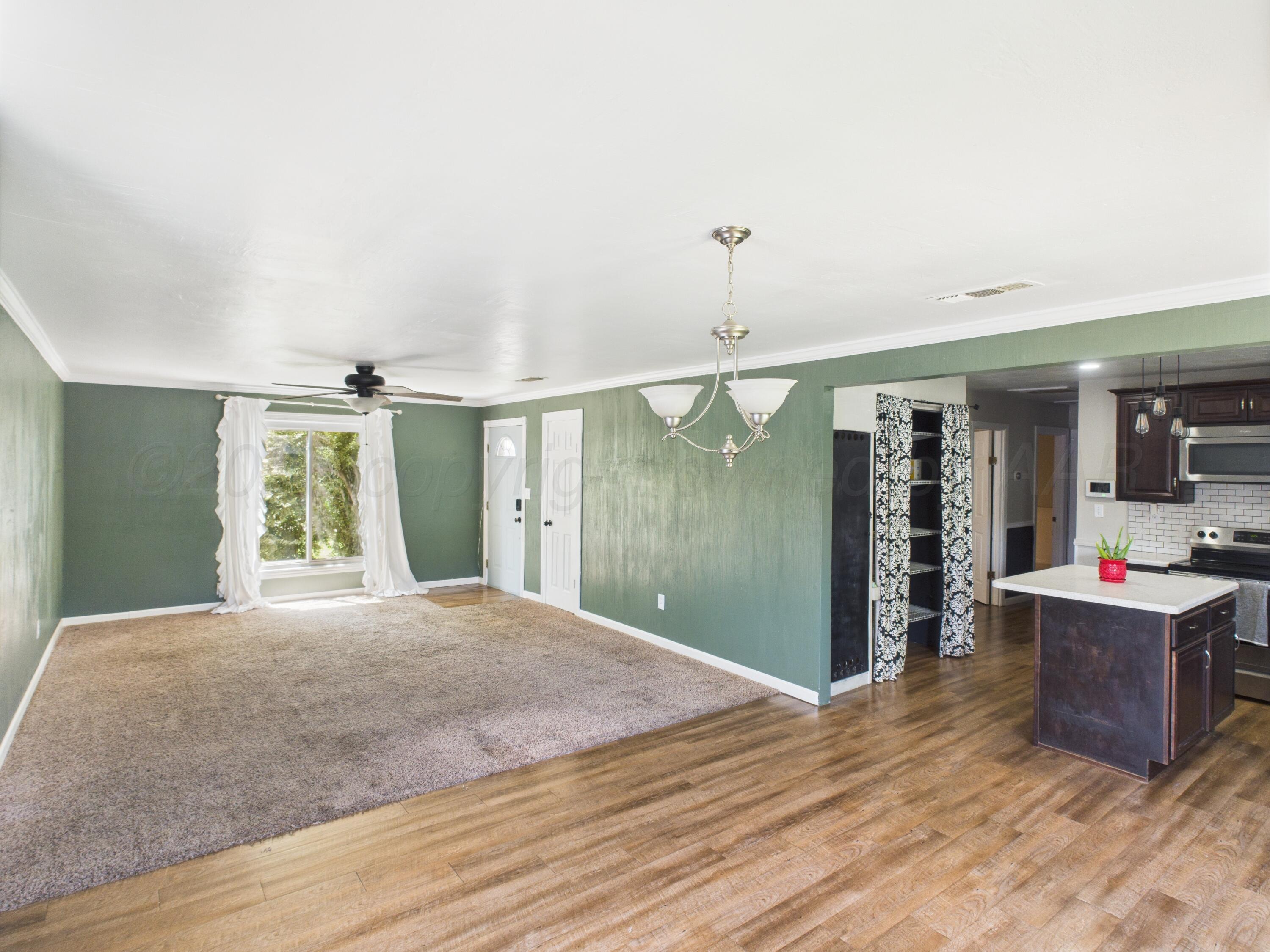 505 South Ridgeland Avenue Fritch, TX 79036 - Photo 5 of 15 a living room with kitchen island furniture and a window