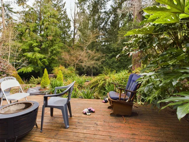 a backyard of a house with table and chairs