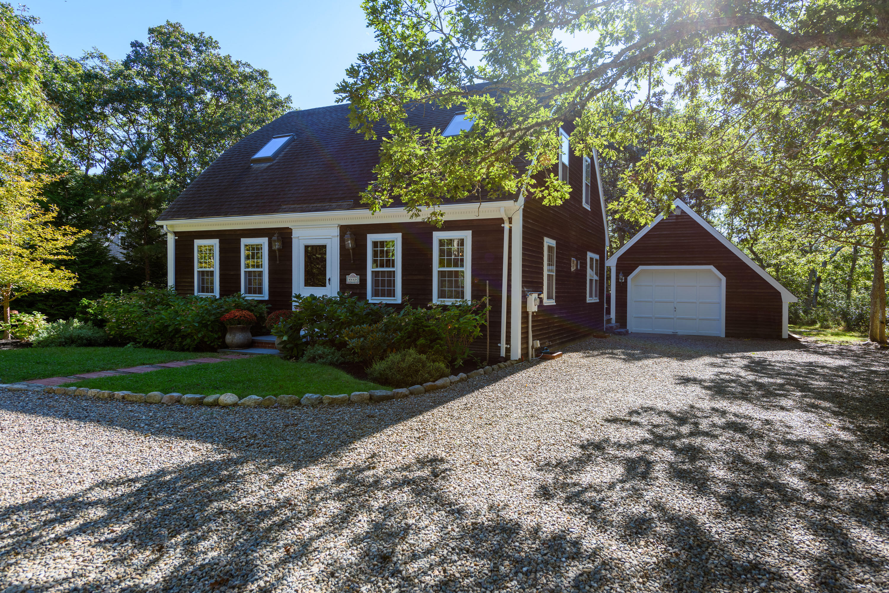 44 Marthas Road Edgartown, MA 02539 - Photo 1 of 30 a front view of a house with a yard and garage