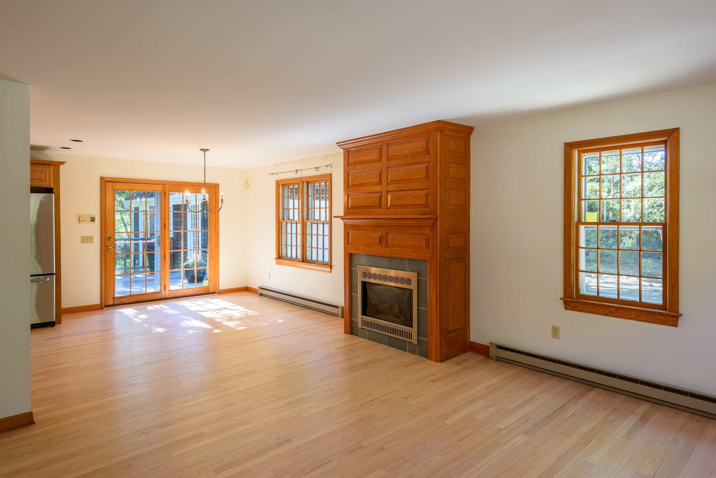 44 Marthas Road Edgartown, MA 02539 - Photo 13 of 30 an empty room with windows fireplace and wooden floor