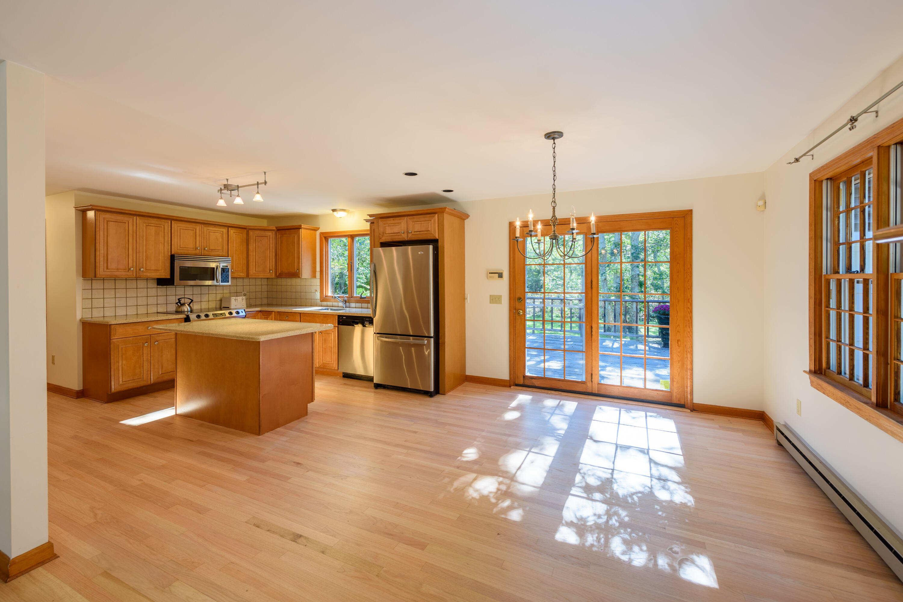 44 Marthas Road Edgartown, MA 02539 - Photo 17 of 30 a view of a kitchen with kitchen island wooden floors stainless steel appliances and a window