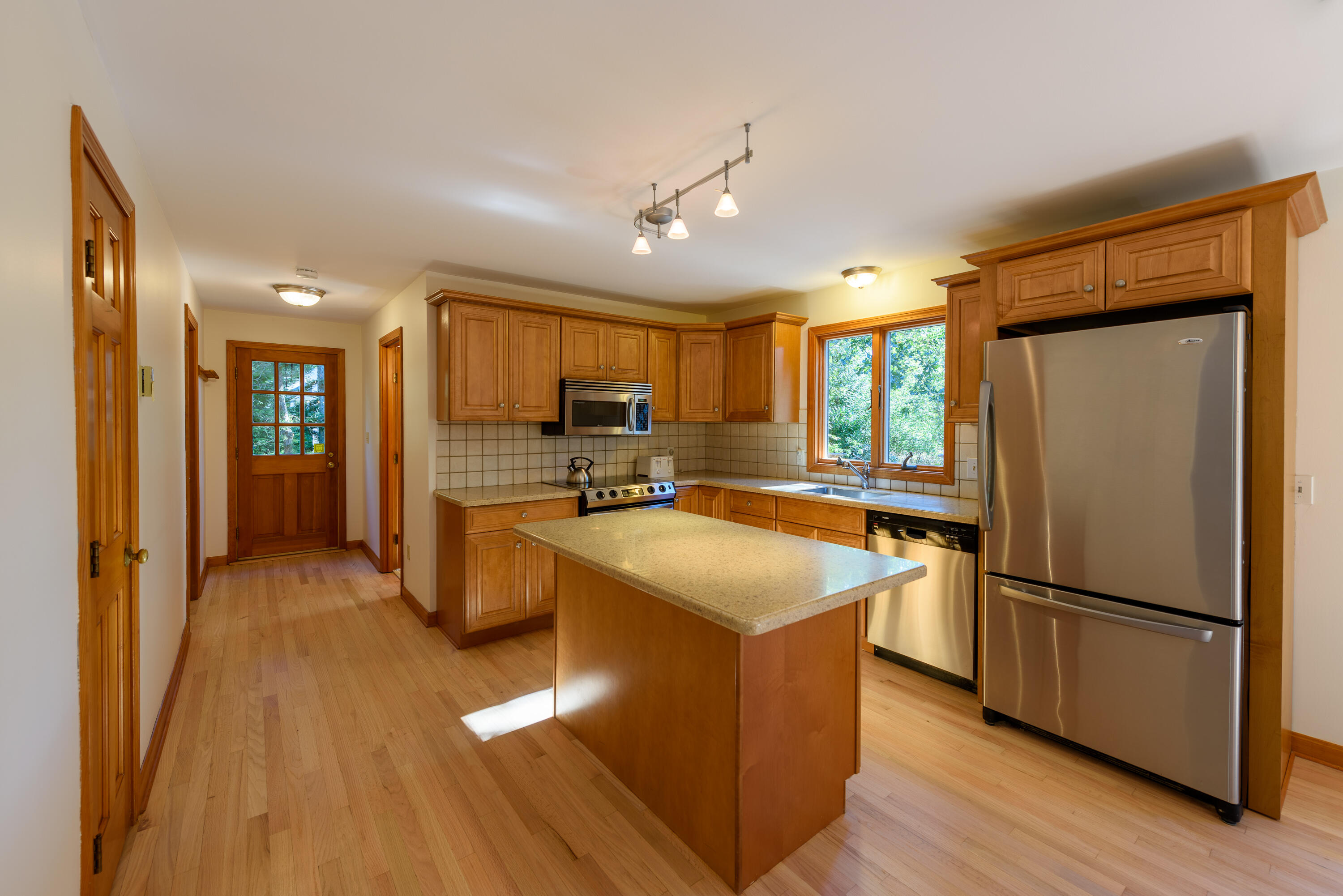 44 Marthas Road Edgartown, MA 02539 - Photo 19 of 30 a kitchen with kitchen island a counter top space a sink a refrigerator and a stove top oven