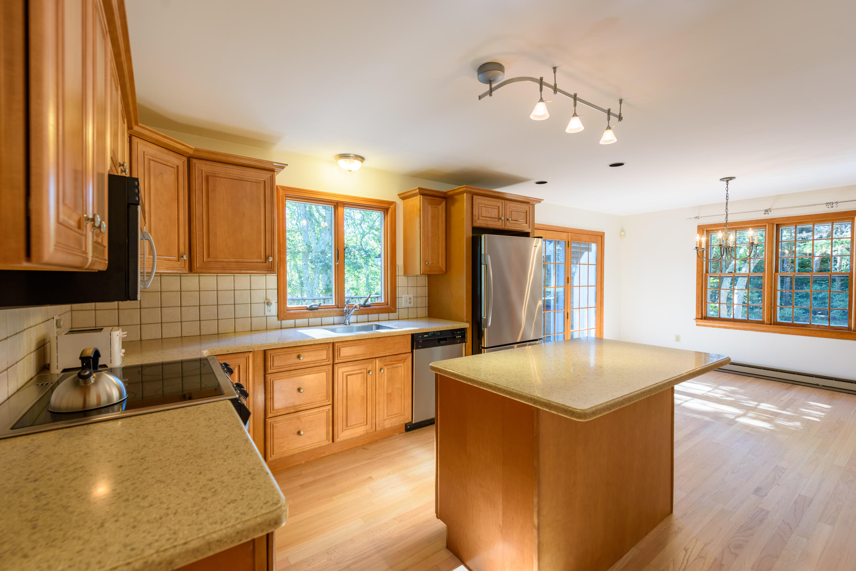 44 Marthas Road Edgartown, MA 02539 - Photo 20 of 30 a large kitchen with kitchen island a stove a sink a dining table and chairs
