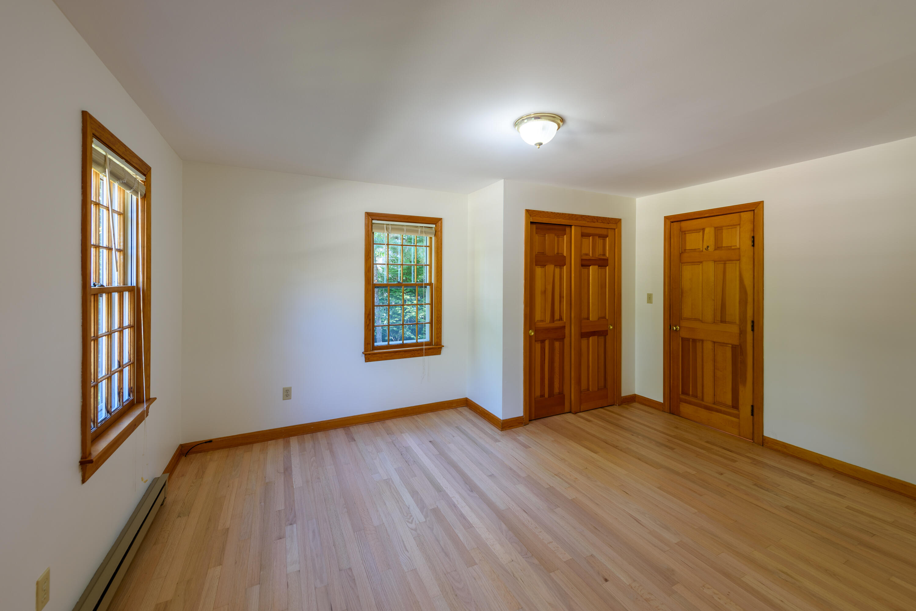 44 Marthas Road Edgartown, MA 02539 - Photo 22 of 30 an empty room with wooden floor and windows