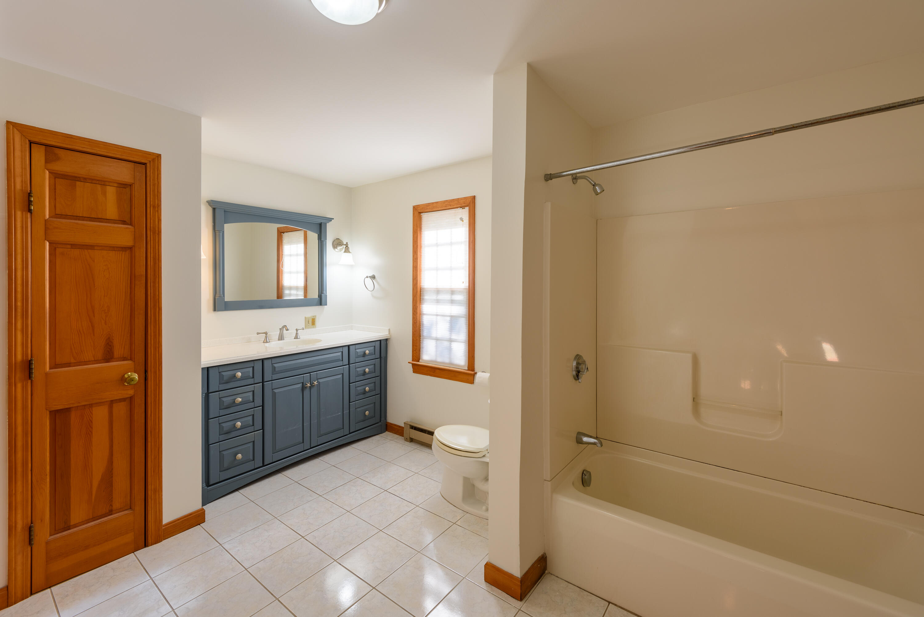 44 Marthas Road Edgartown, MA 02539 - Photo 27 of 30 a spacious bathroom with a bathtub sink mirror vanity and a toilet